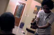 Gallery image from movie. A crazy woman holds a man at gunpoint.