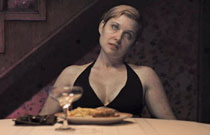 Gallery image from movie. Zombie woman at dinner table.