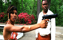 Gallery image from movie. Woman points a gun.