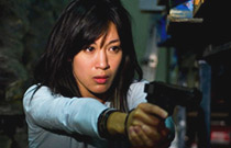Gallery image from movie. Girl points a gun.