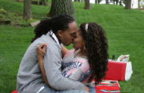 Gallery image from movie. Two people kissing in the park.