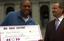 Isaac gets his big lottery check.