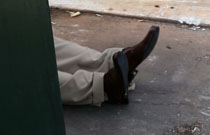 Dead body behind dumpster.