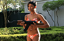 Girl in bikini holding a rifle.