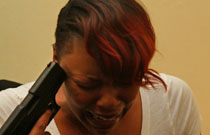 Gallery image from movie. Woman puts a gun to her head.