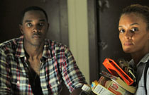 Gallery image from movie. A man and a woman her a startling noise.