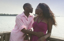 Gallery image from movie. A man and woman standing on a dock.